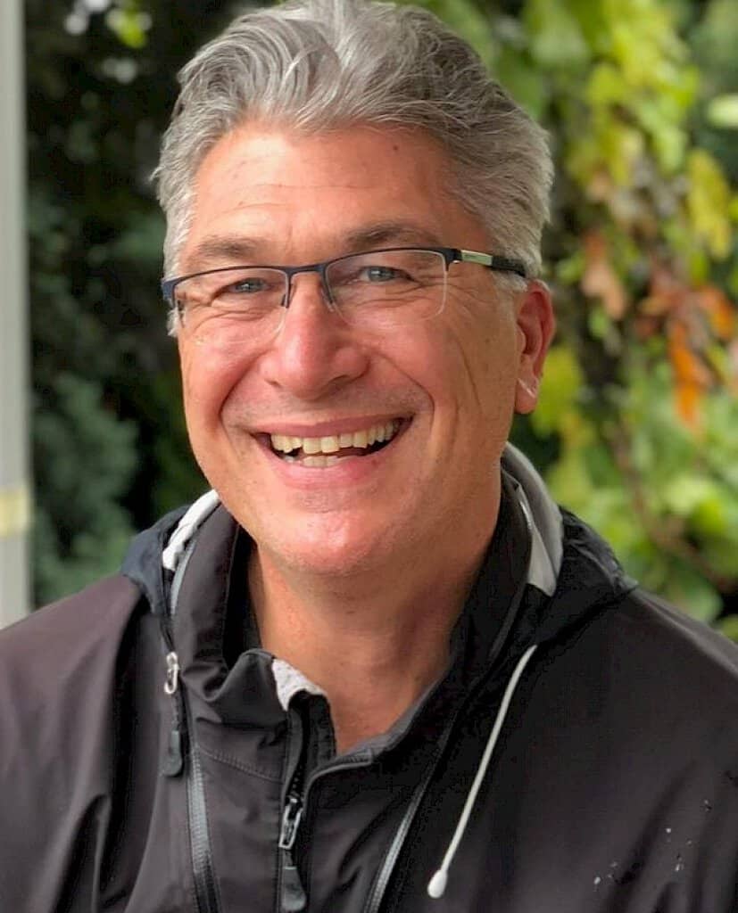 Sean Penrith headshot. Smiling, outdoors.